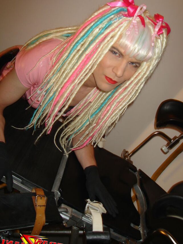 15P Naughty crazy haired crossdresser wearing pink pvc gets ready to go on the