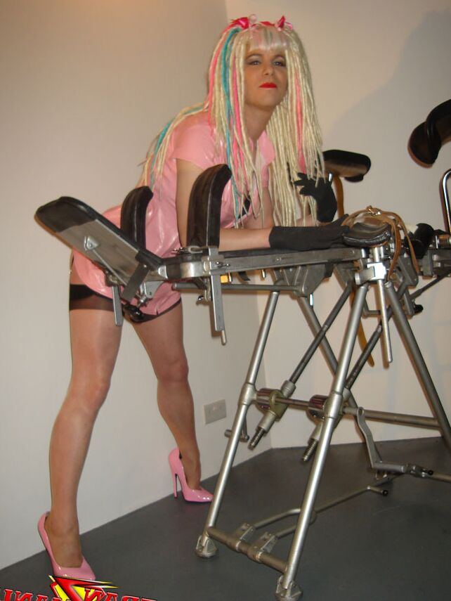 15P Naughty crazy haired crossdresser wearing pink pvc gets ready to go on the
