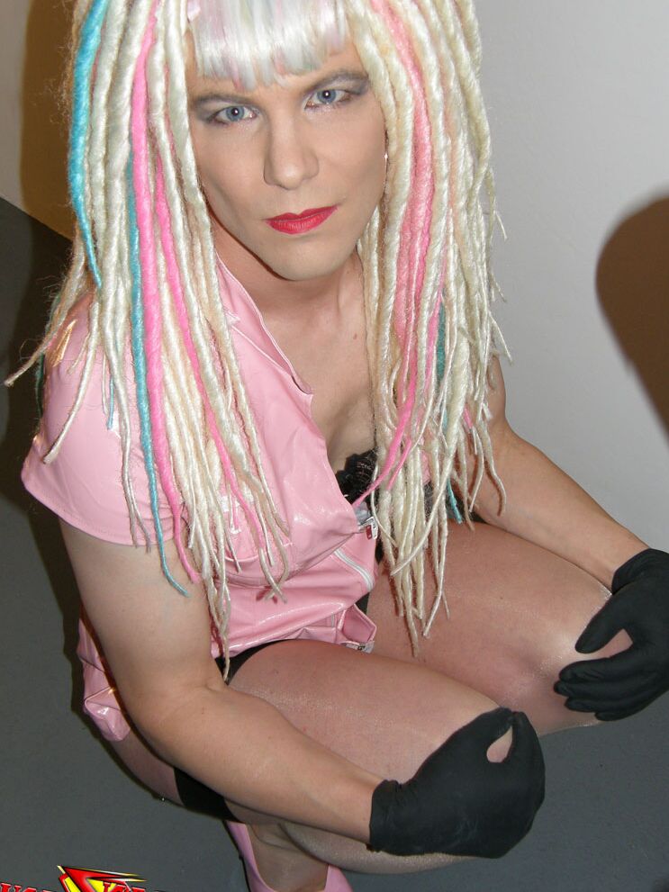 15P Naughty crazy haired crossdresser wearing pink pvc gets ready to go on the
