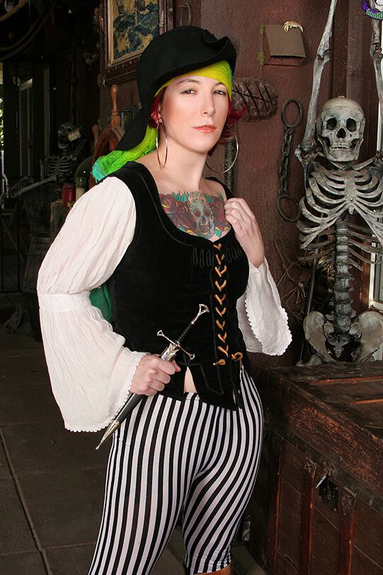 15P Tattooed redhead Zelda ditches pirate attire to pose nude in boots and a hat