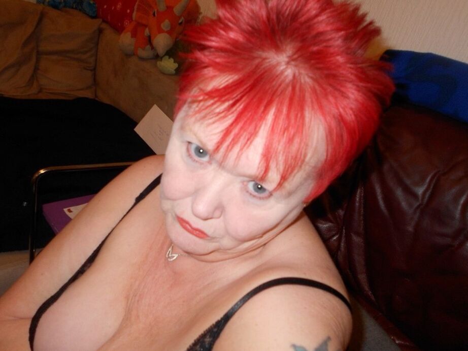 20P Older redhead Valgasmic Exposed removes her boots while wearing fishnets