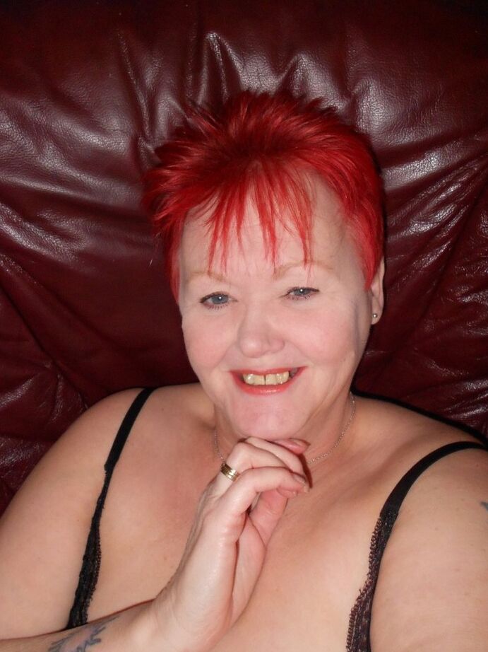 20P Older redhead Valgasmic Exposed removes her boots while wearing fishnets