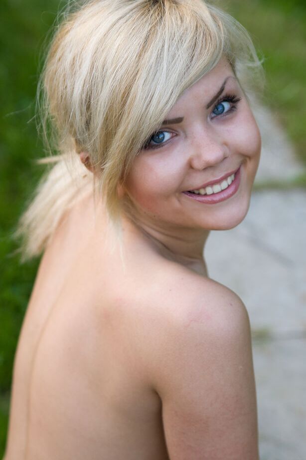16P Cute young blonde Iveta poses in the nude while in a garden