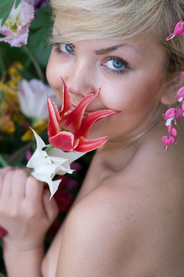 16P Cute young blonde Iveta poses in the nude while in a garden