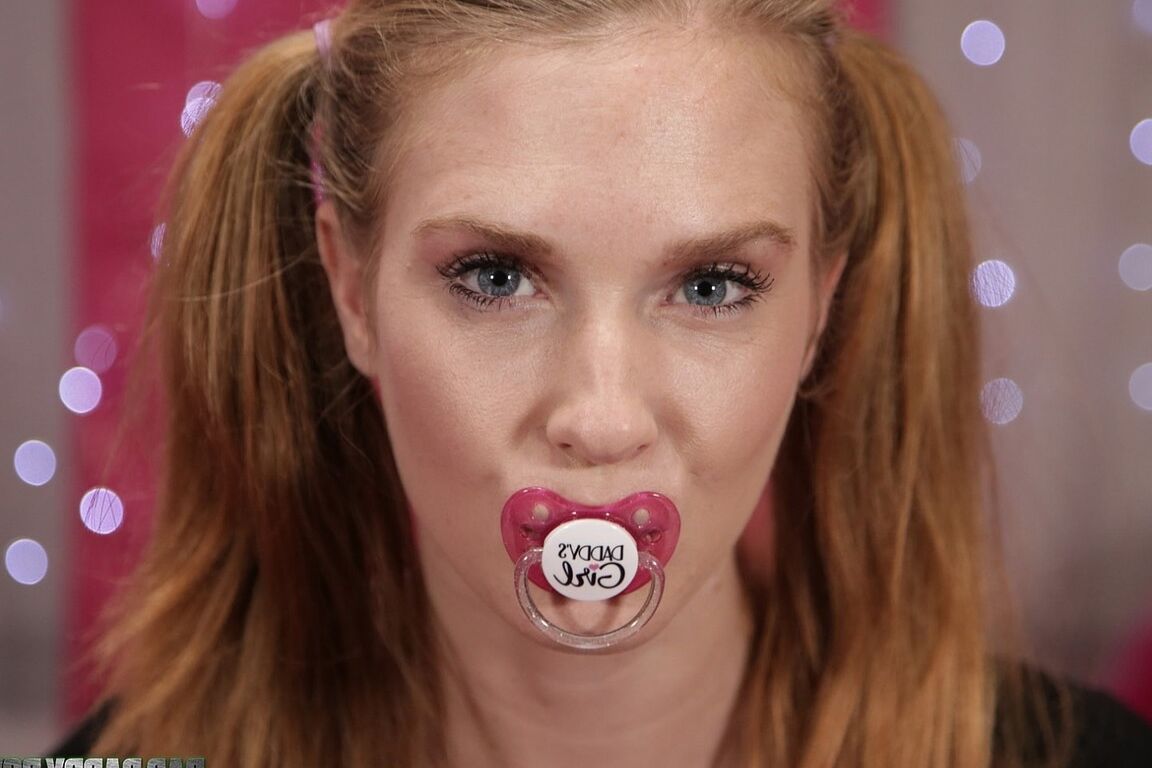 21P Redhead teen Ashley Lane sucks on a plastic nipple while posing in panties