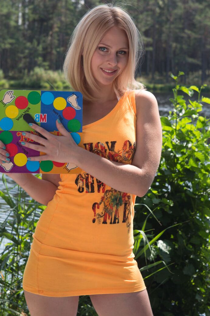20P Young blonde Emma exposes her bald slit while getting naked near a river
