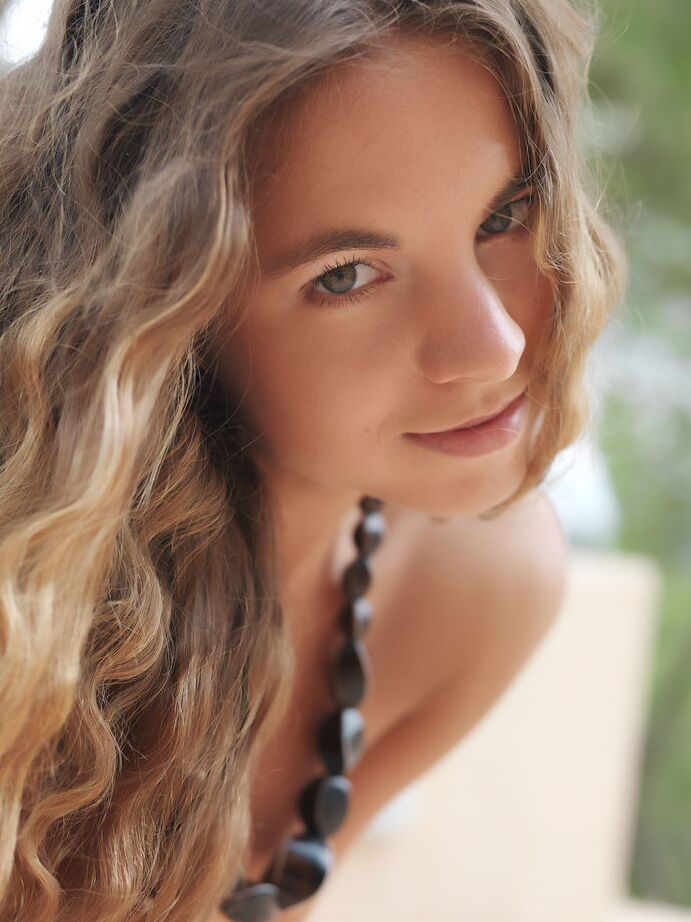 18P La joven Altea B frunce los labios después de grandes poses desnudas en un patio entre árboles