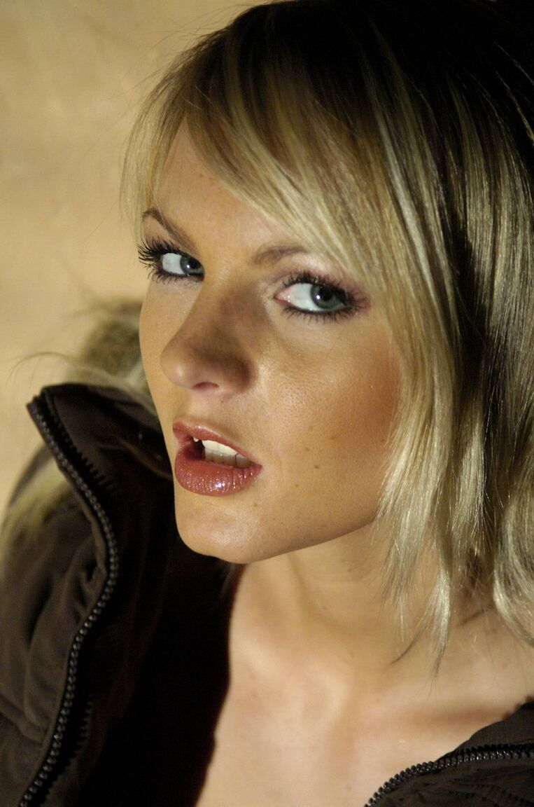 16P Beautiful blonde Sandra Sanchez casually frees her small tits from a bra