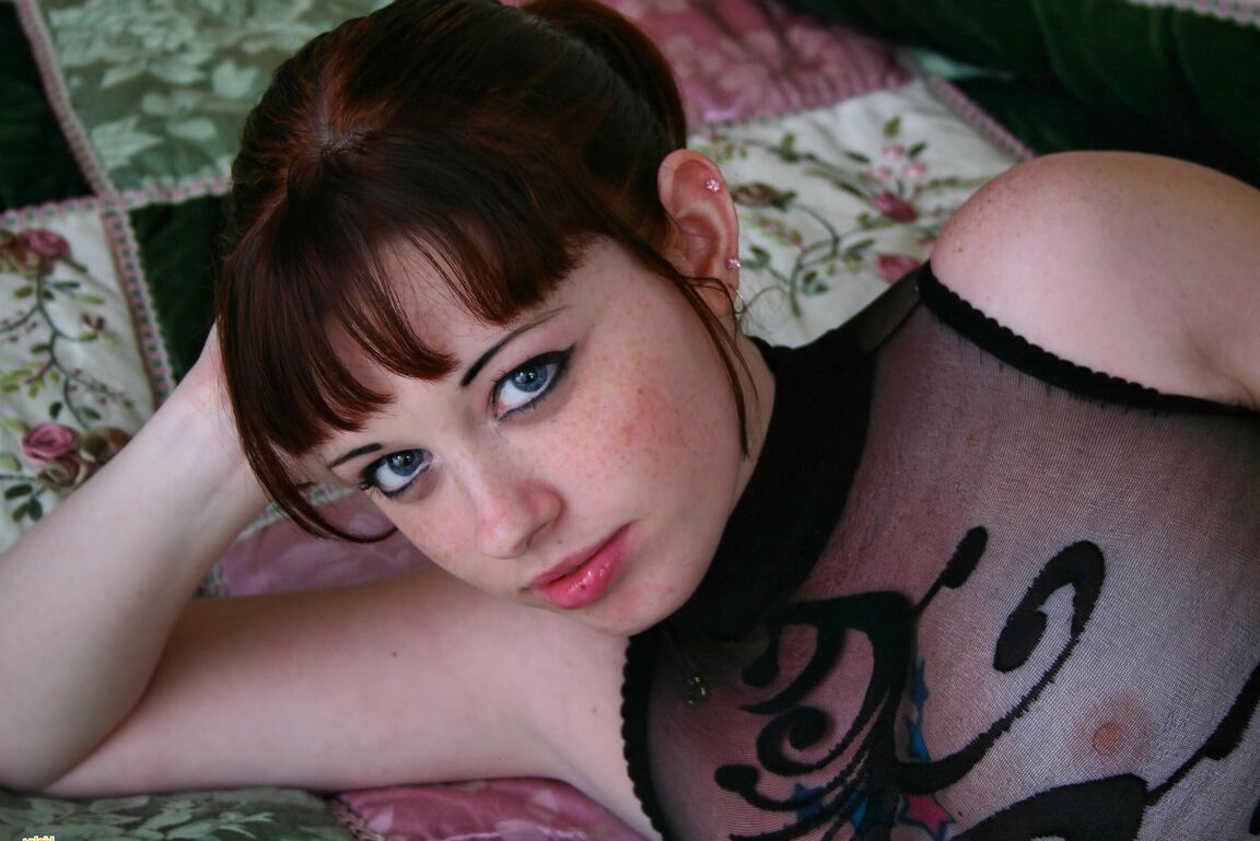 12P Redheaded amateur Barbie A models sheer lingerie and hosiery on a bed