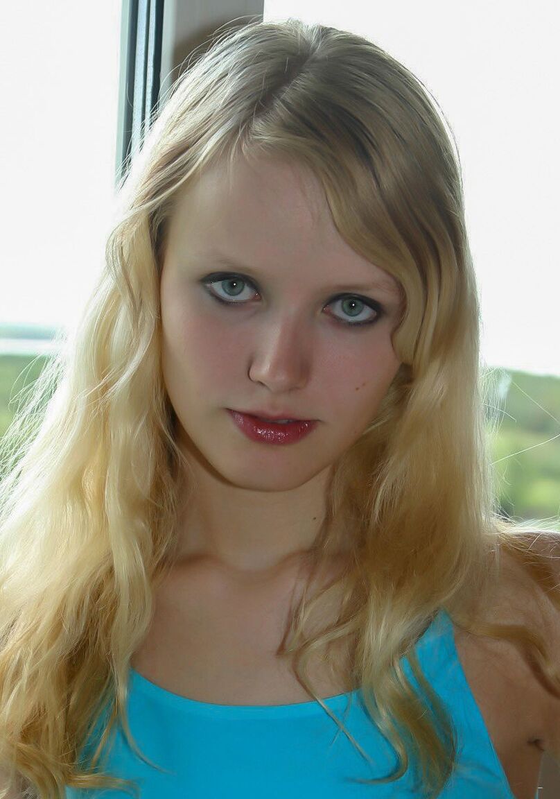 16P 18 year old blonde Yana F strips to her socks in front of a window