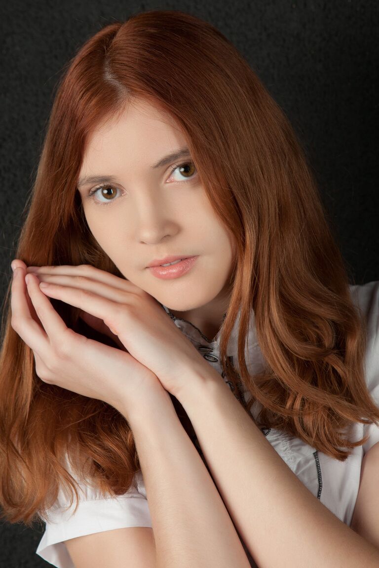 21P Redheaded teen Orabelle A shows her bushy clam and poses in fishnets