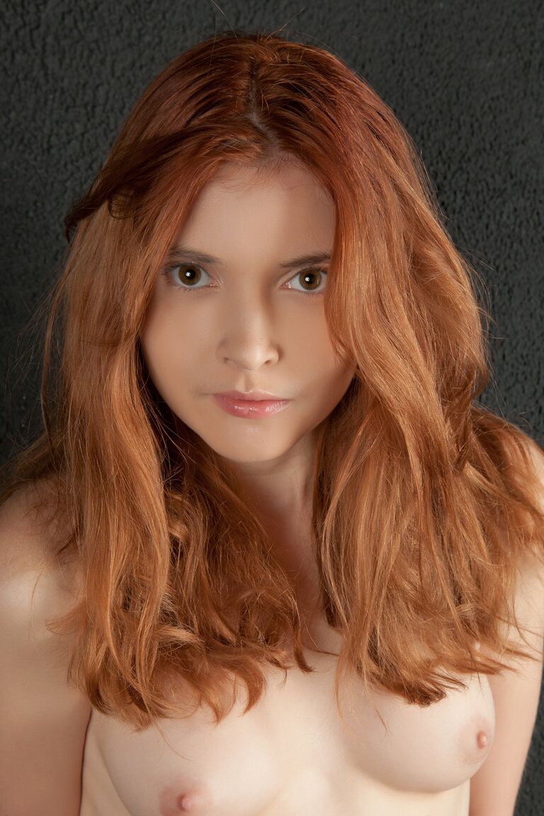 21P Redheaded teen Orabelle A shows her bushy clam and poses in fishnets