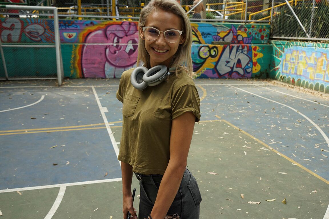 16P Verónica Leal posando sobre toda su capucha con camisa verde y jeans ajustados