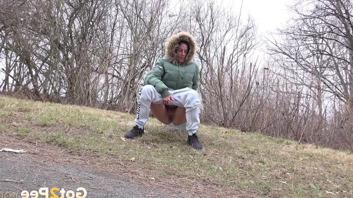 15P Ali B squats on tiptoes to piss by the road