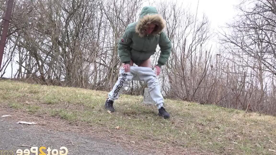 15P Ali B squats on tiptoes to piss by the road