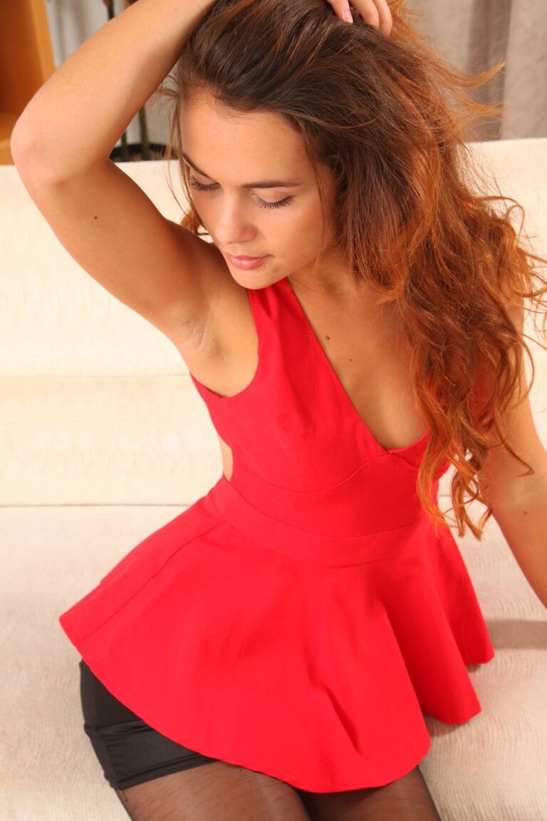 21P Adorable chick Sabina stripping on the couch and showing her medium tits