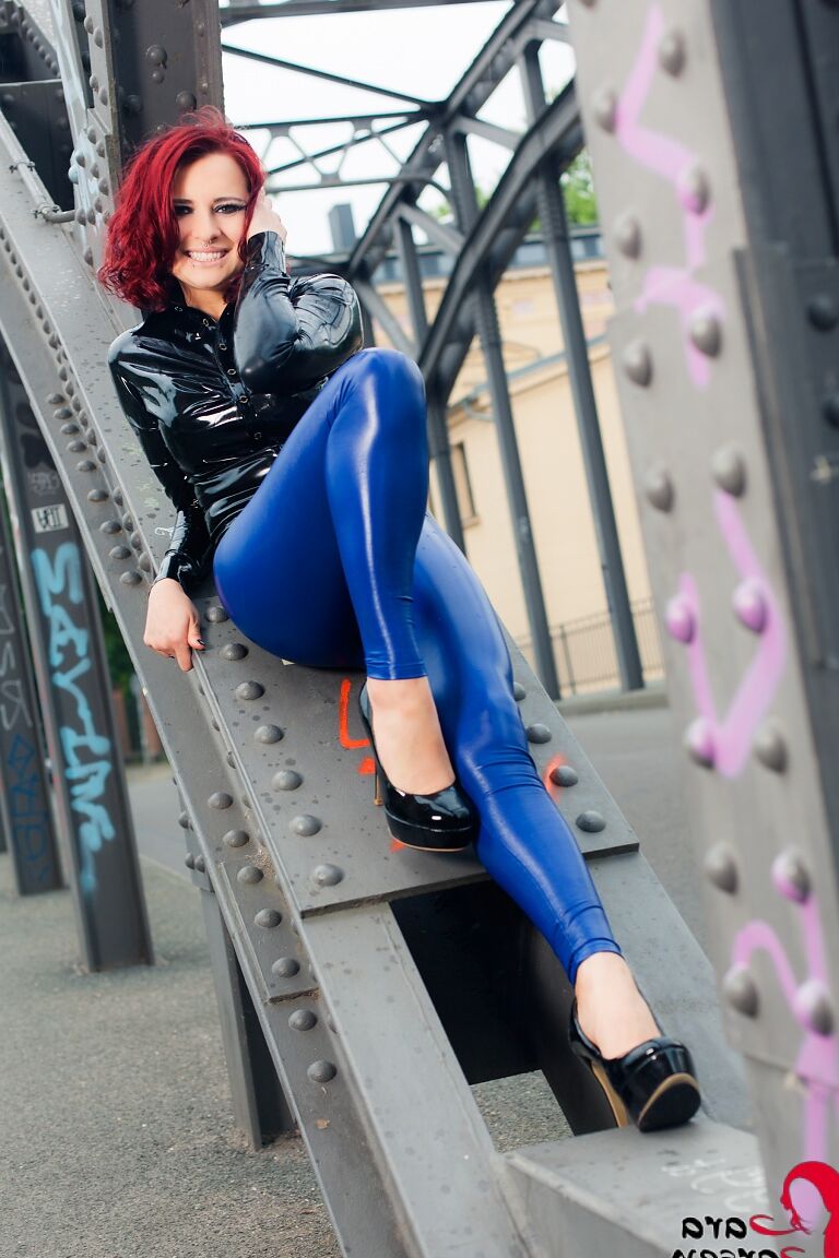 12P Sexy redhead Lara Larsen models non nude in latex and heels on steel girders