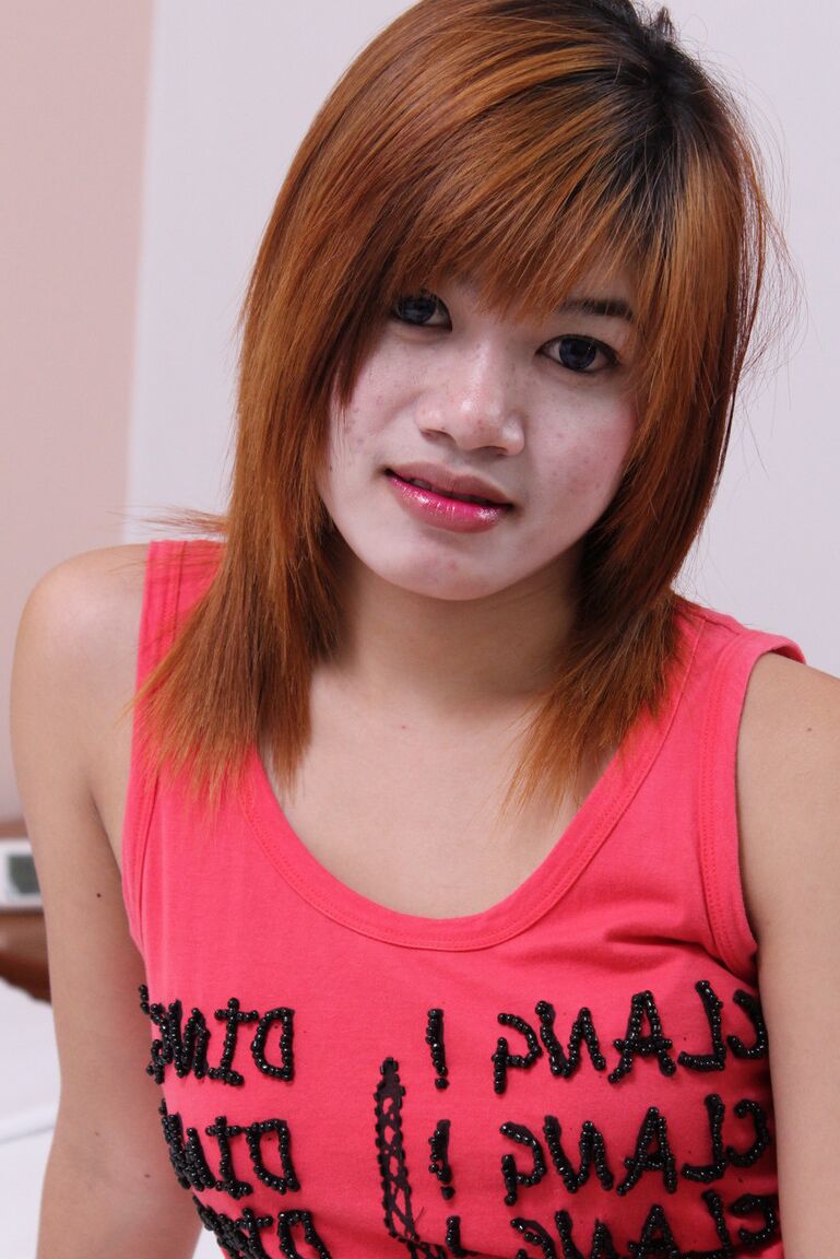 15P Young Asian redhead Oam looses her hairy muff from a bikini as she gets naked