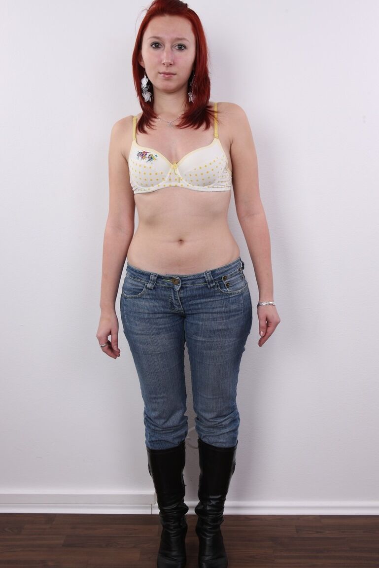 20P Redhead amateur Monika takes a seat on a stool after standing naked