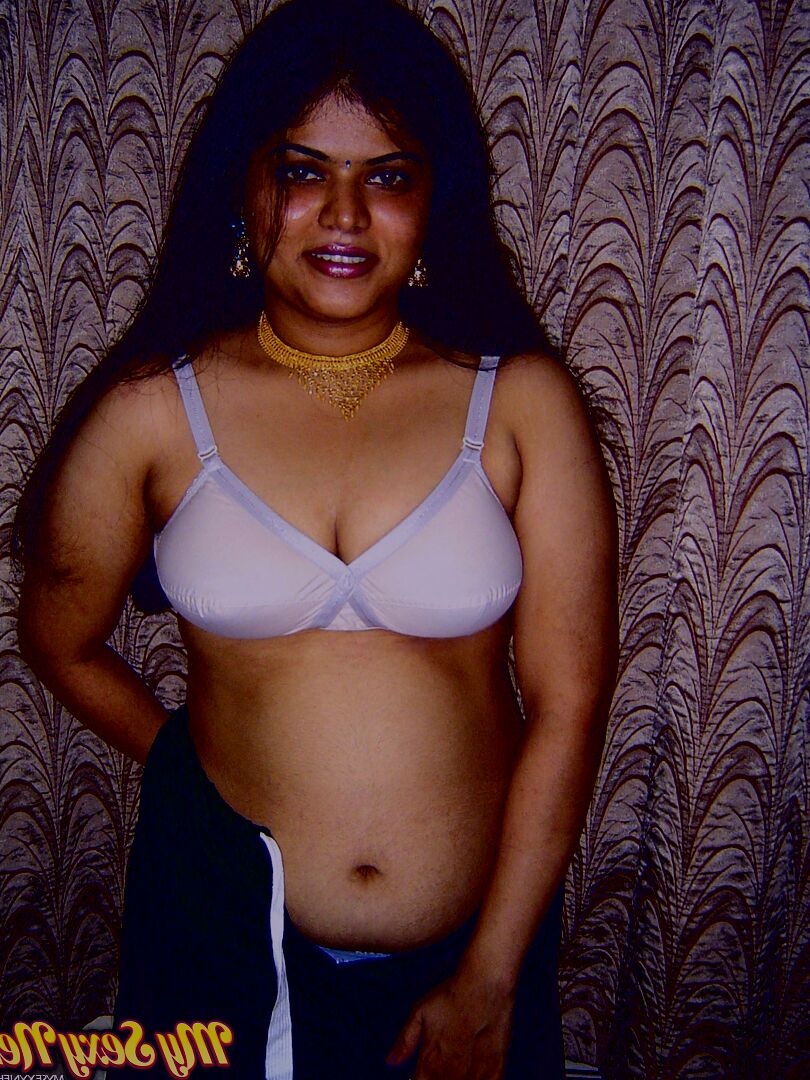 12P Chubby Indian girl Neha Nair lets her boobs spill forth from white bra