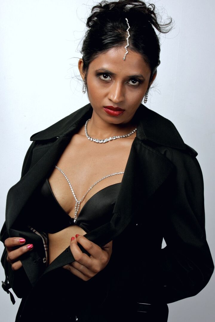 15P Beautiful Indian female sheds an overcoat to model in underwear and stockings
