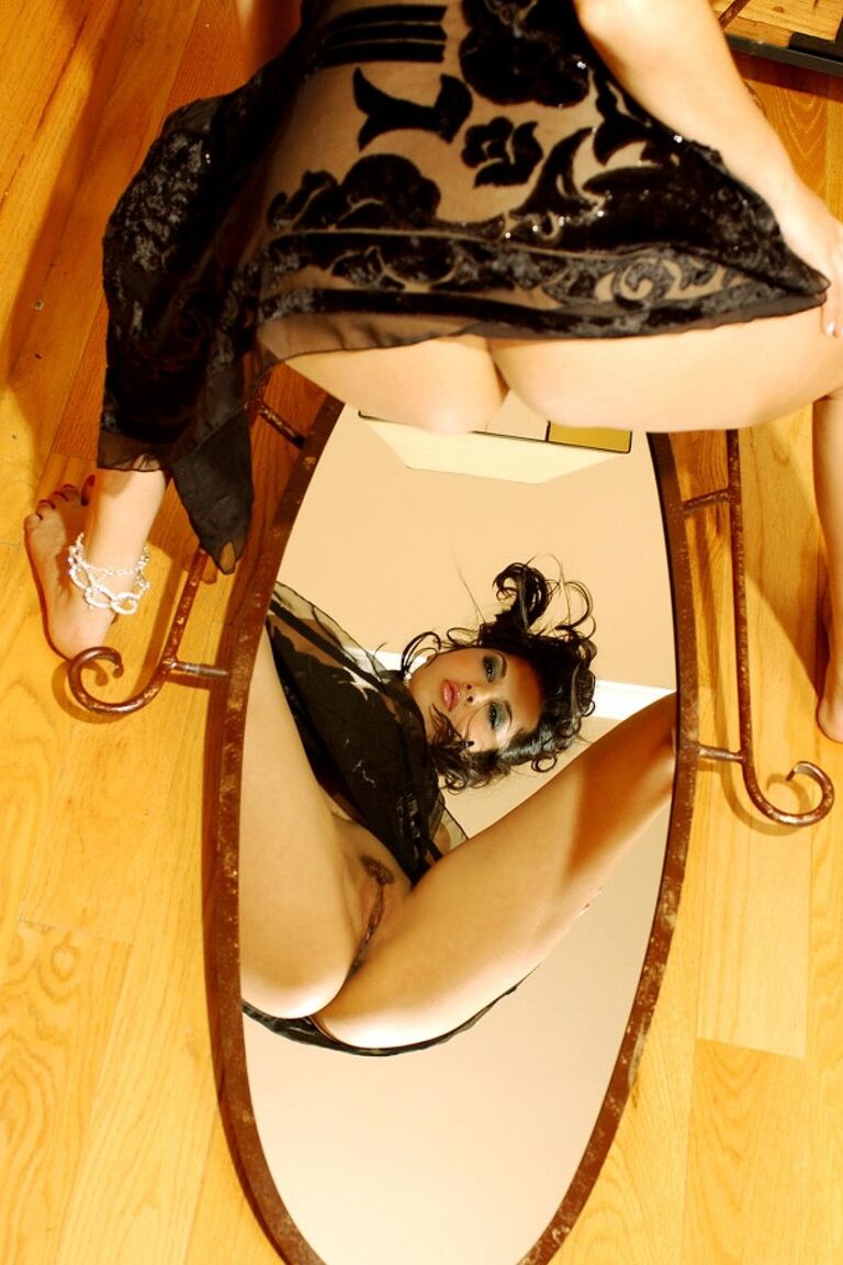 17P Classy Indian babe Sunny Leone admires herself in a mirror at top of stairs