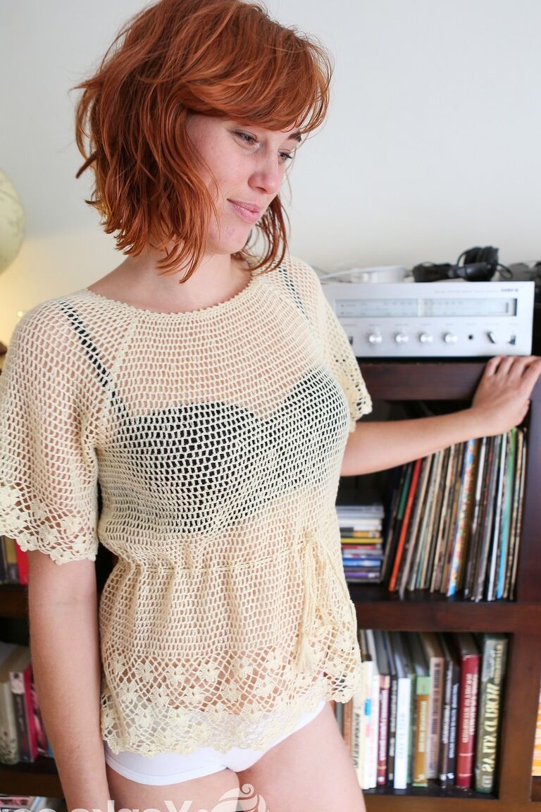 17P Pale redhead Molly Broad strips by the bookcase to flaunt her hairy muff