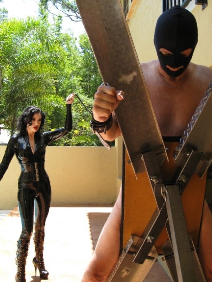 16P Femdom in hot latex outfit Jean Bardot whipping her tied up slave's back