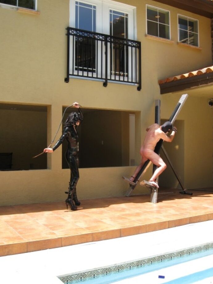 16P Femdom in hot latex outfit Jean Bardot whipping her tied up slave's back