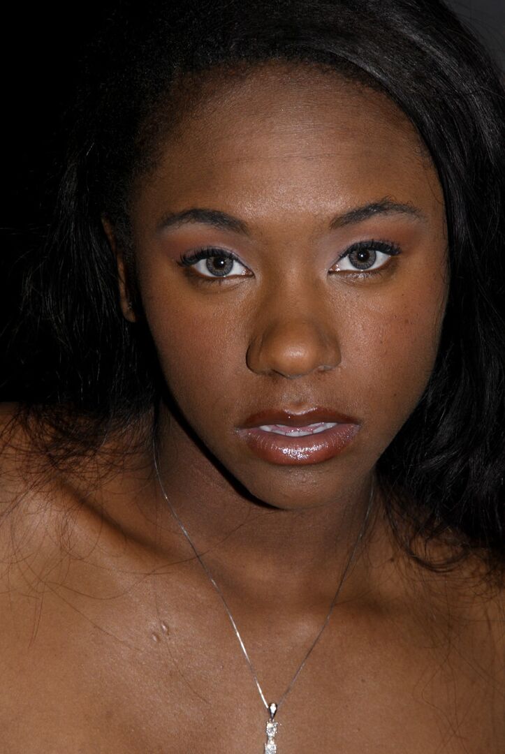 20P Skinny ebony MILF Hailey Young flashes her panties while posing in the dungeon