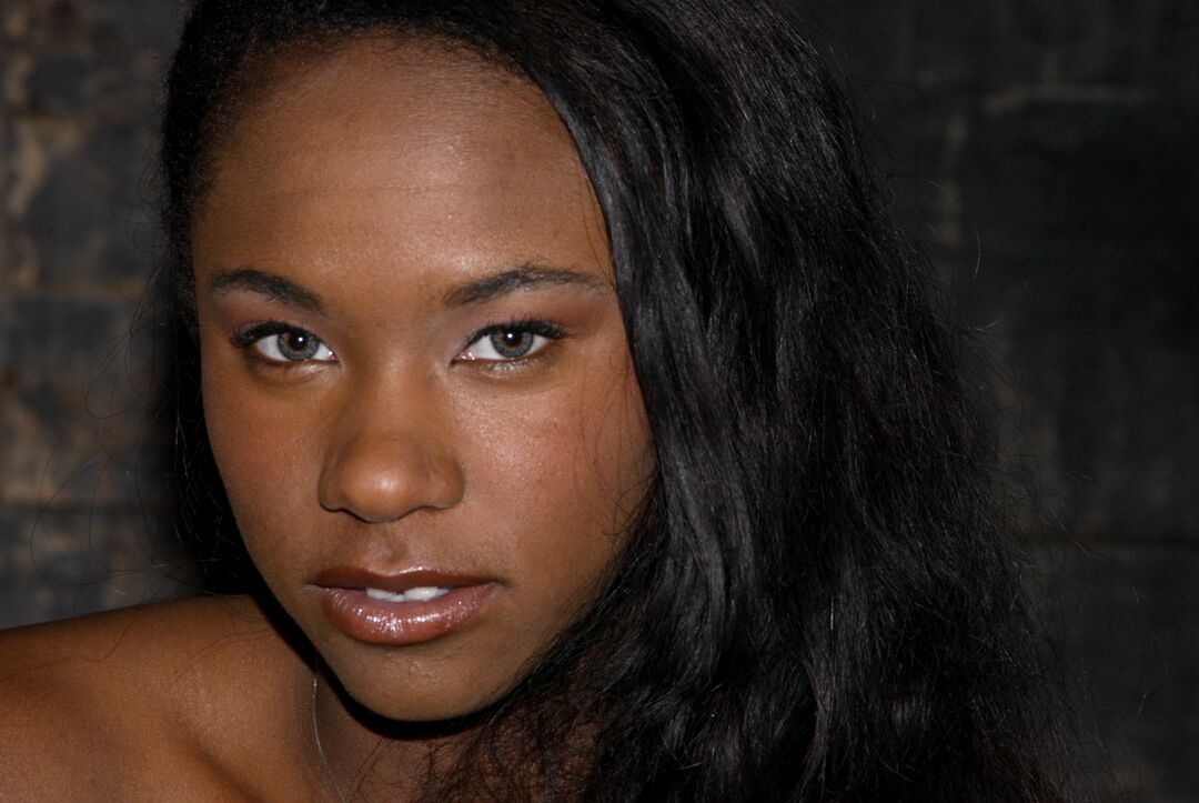 20P Skinny ebony MILF Hailey Young flashes her panties while posing in the dungeon