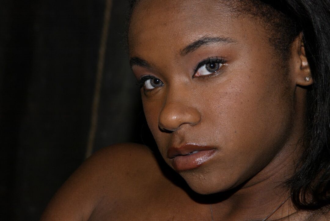 20P Skinny ebony MILF Hailey Young flashes her panties while posing in the dungeon