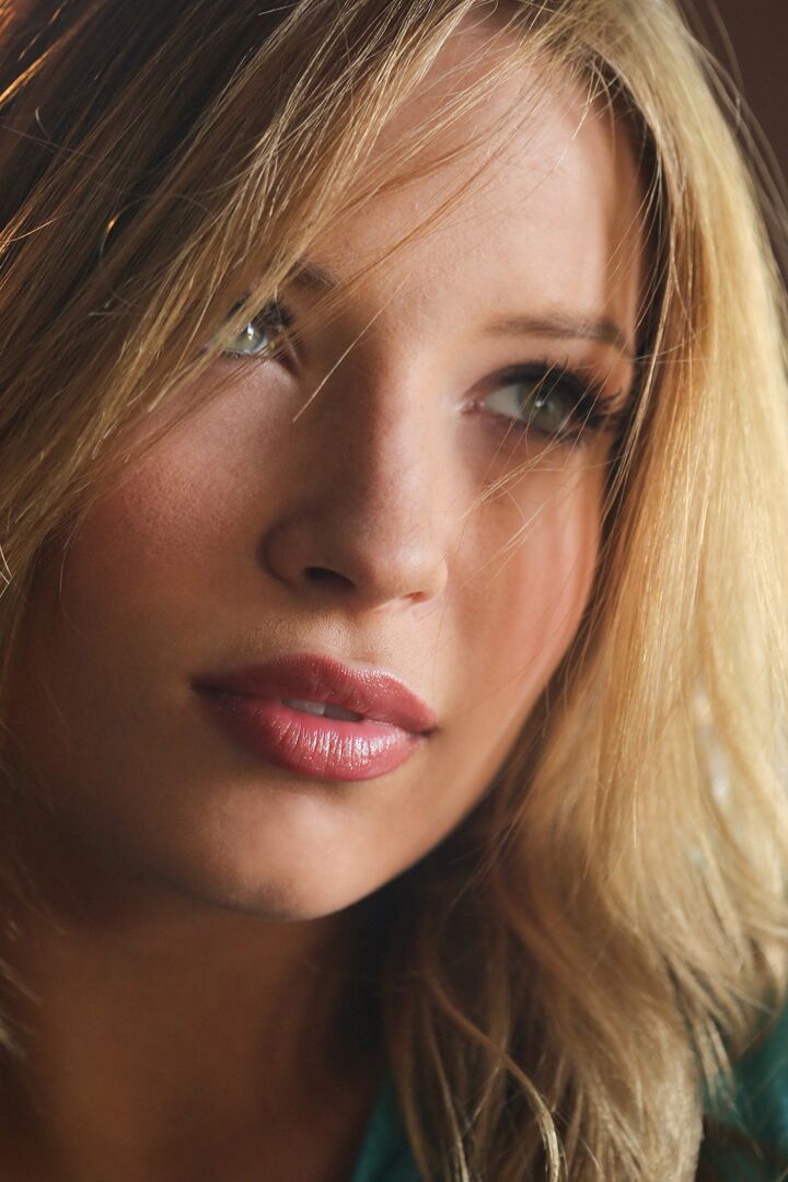 15P Beautiful blonde Alyssa Branch gets completely naked on a fabric sofa
