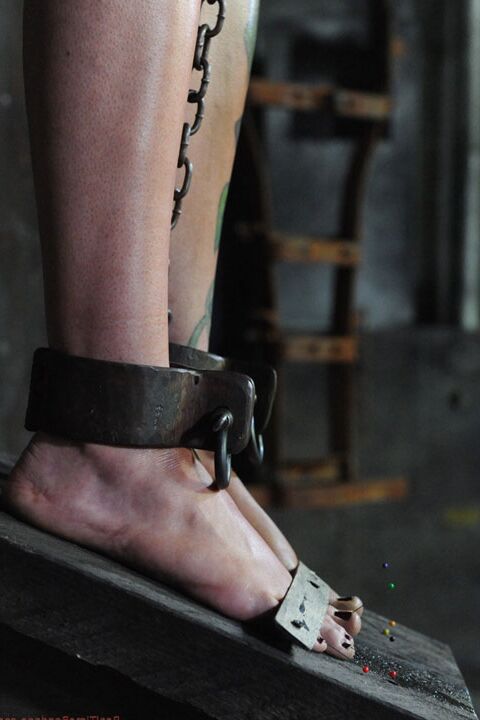 16P Tattooed blonde Rain Degrey is restrained for lezdom sex in a dungeon