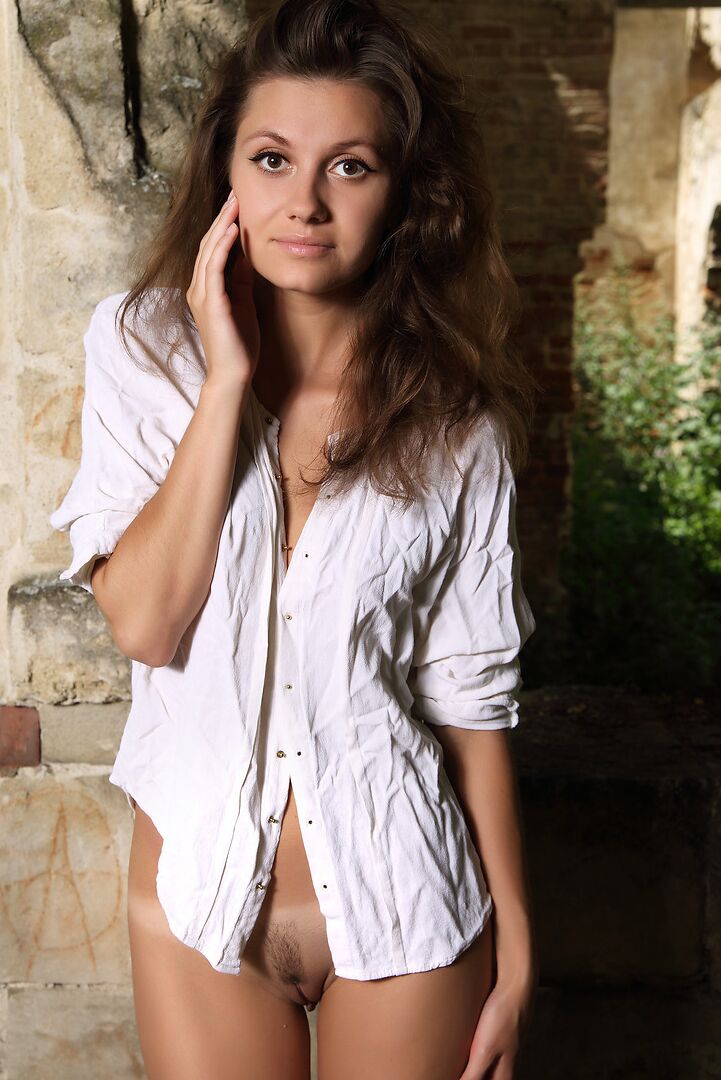 12P Attractive brunette roams around the ruins naked showing off her hairy muff