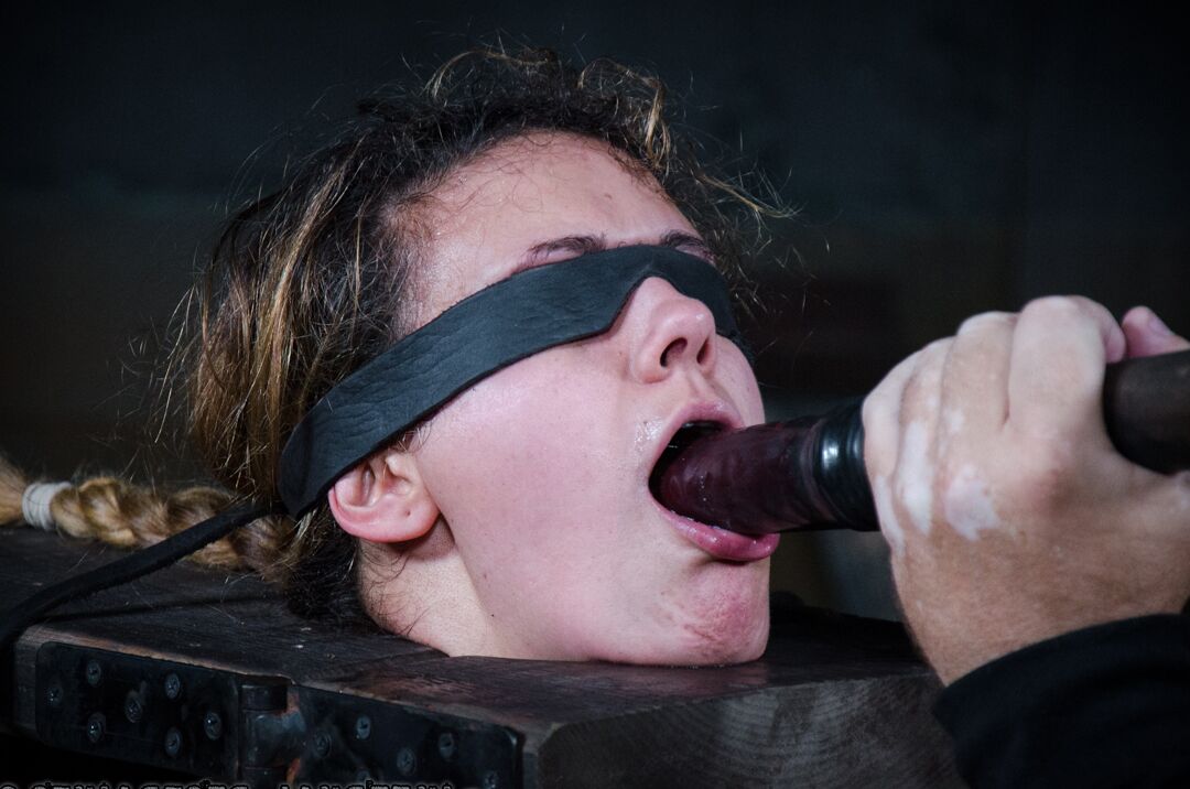 14P Nude white girl Penny Barber sports an oily body while restrained in a dungeon