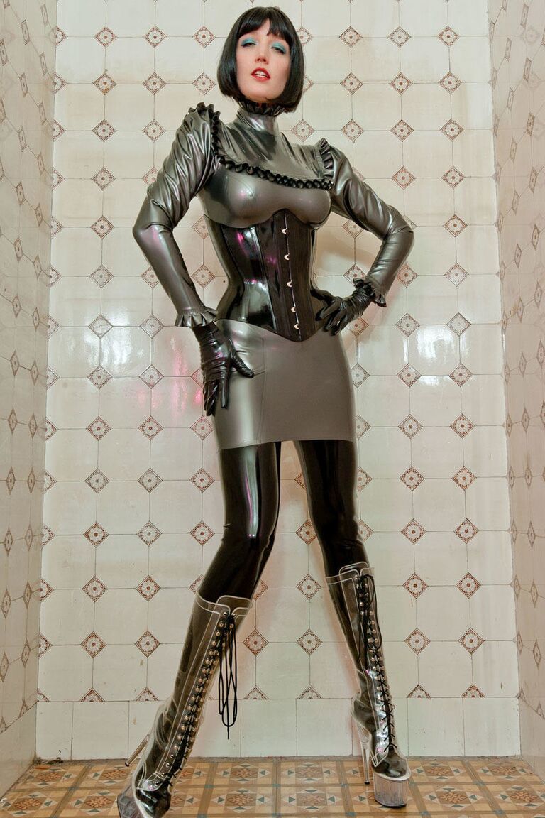 16P Latex enthusiast dons rubber gloves and hood in silver dress and waist cincher