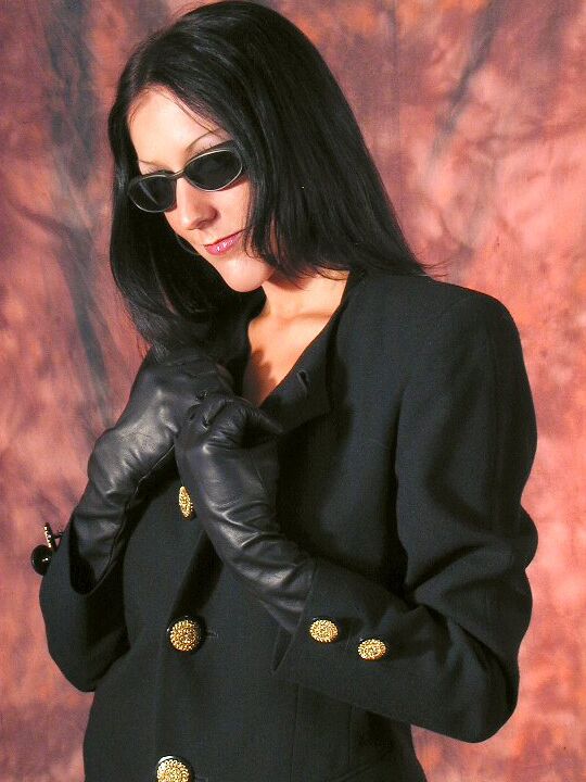 15P Dark haired Domme wields a sword in long leather gloves and bondage lingerie