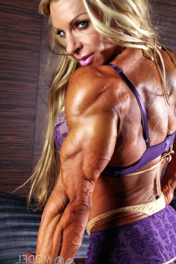 21P Blonde bodybuilder Debi Laszewski shows her huge tanned muscles in a solo
