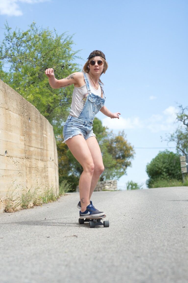 12P Skater girl Pippa Doll skoots down a hill wearing nothing more than a ballcap