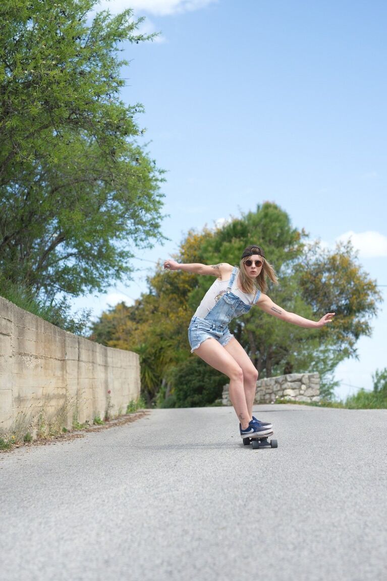 12P Skater girl Pippa Doll skoots down a hill wearing nothing more than a ballcap