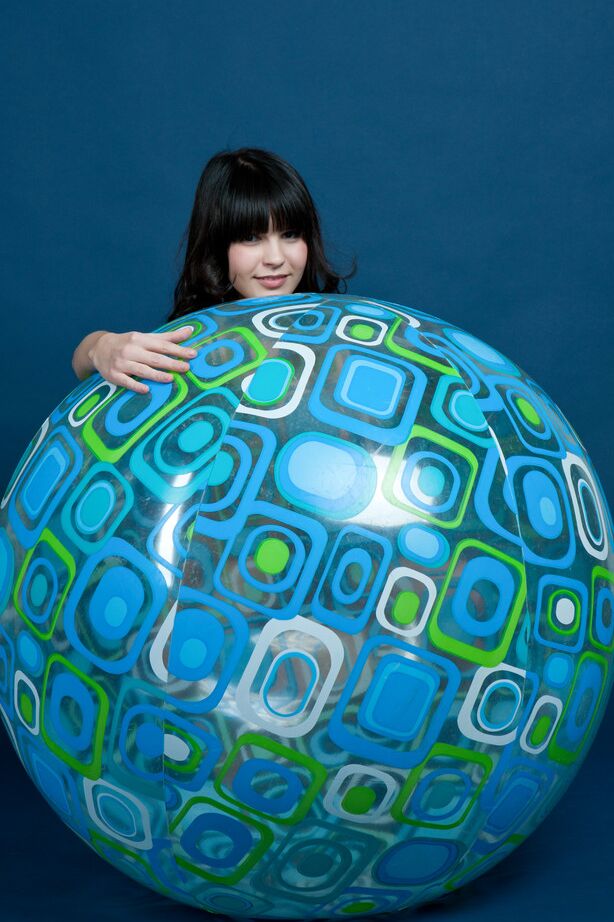 16P Beautiful dark-haired teen Zelda holds a ball while modelling in the nude