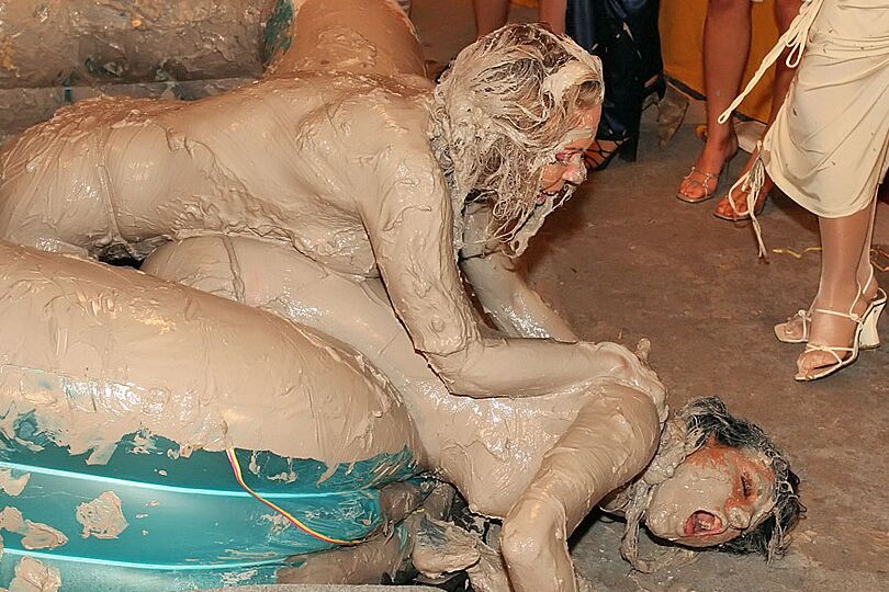 15P Naked females participate in a filthy mud wrestling competition