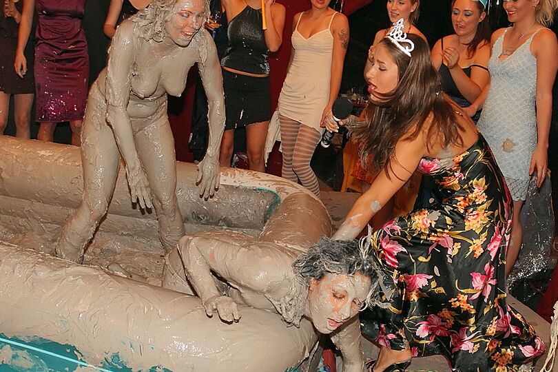 15P Naked females participate in a filthy mud wrestling competition