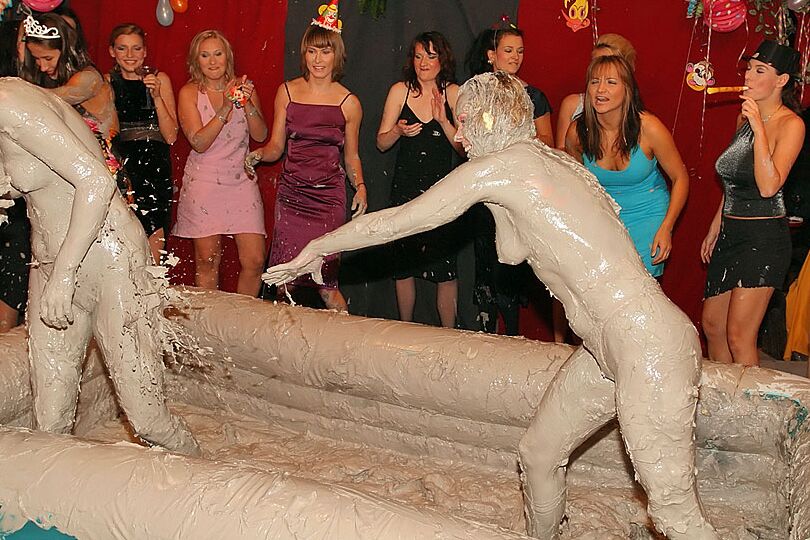 15P Naked females participate in a filthy mud wrestling competition