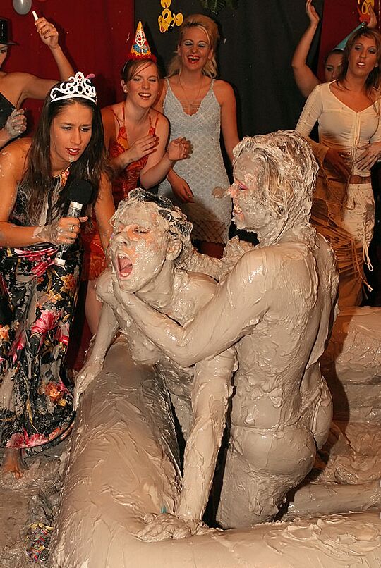 15P Naked females participate in a filthy mud wrestling competition