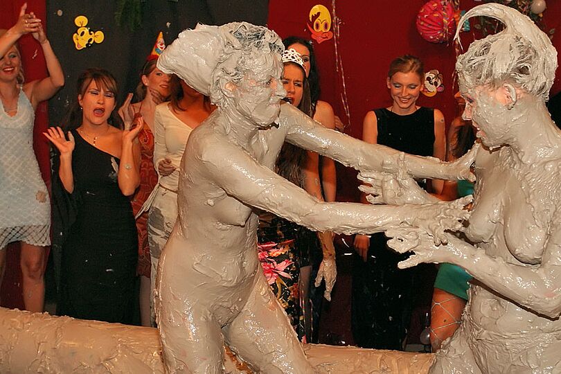 15P Naked females participate in a filthy mud wrestling competition