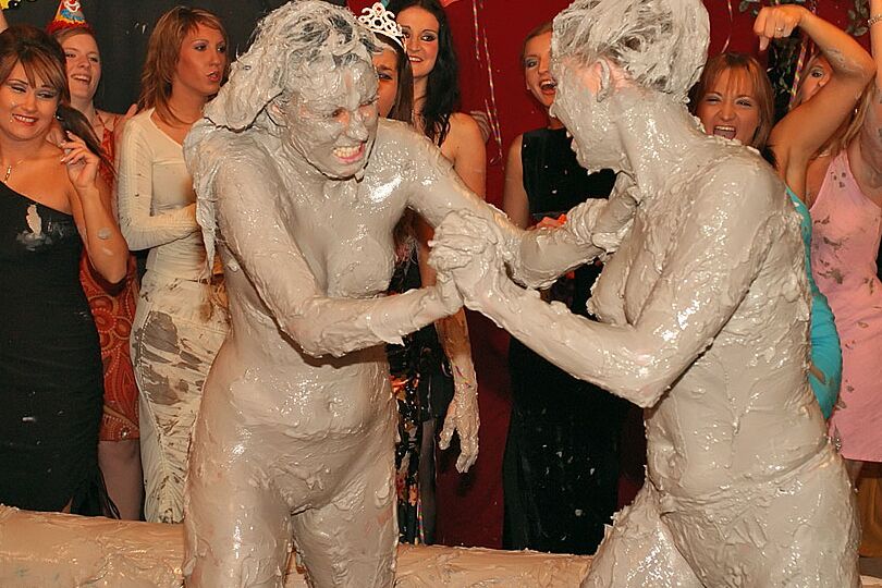 15P Naked females participate in a filthy mud wrestling competition