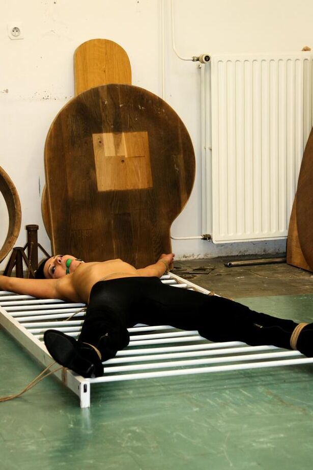 16P Dark haired female with tiny tits is ball gagged and tied to improvised rack