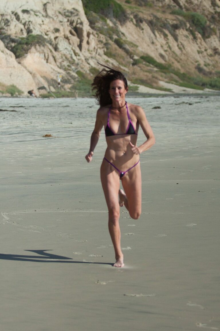 21P Sexy all-natural mature Sofie Marie runs on the beach in a very skimpy bikini